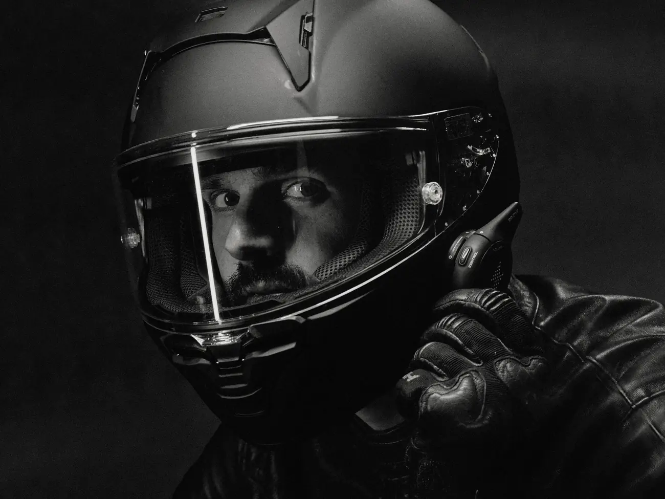 Rider in a black full-face helmet reaching for the Rogue control ring